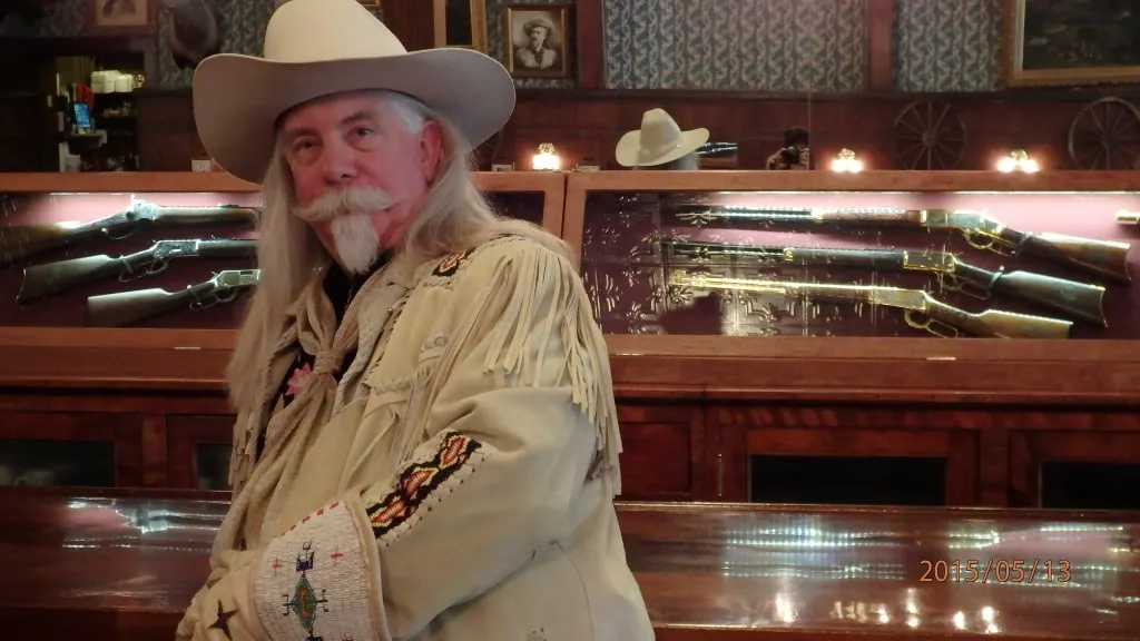 Buffalo Bill impersonator Gunny Jeff Norman in front of the gun collection at the Irma Hotel bar in Cody WY