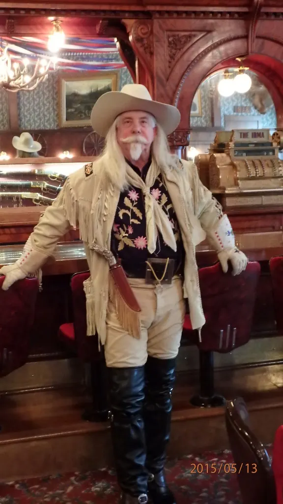 Buffalo Bill Experience standing at the same bar that Bill stood at that was given to him by Queen Victoria, in Bill's Irma Hotel 