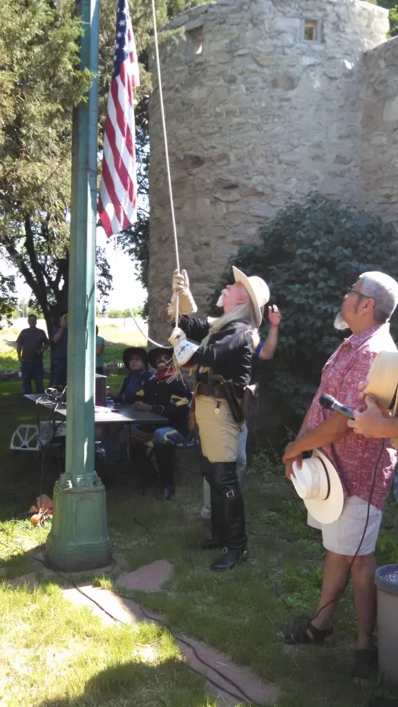 Buffalo Bill historical speaker Gunny Jeff proudly raising the flag at the Overland Trail Museums 4th of July opening ceremony
