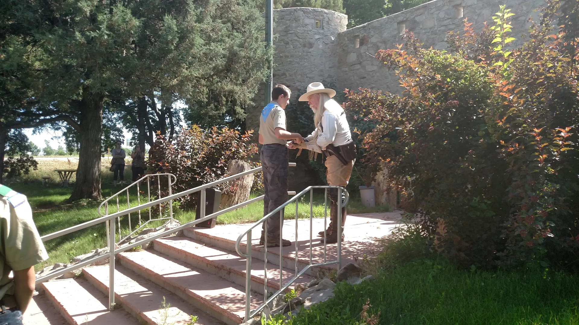 "Buffalo Bill" proudly receiving the flag from a local Boy Scout at the Overland Trail 4th of July opening ceremony