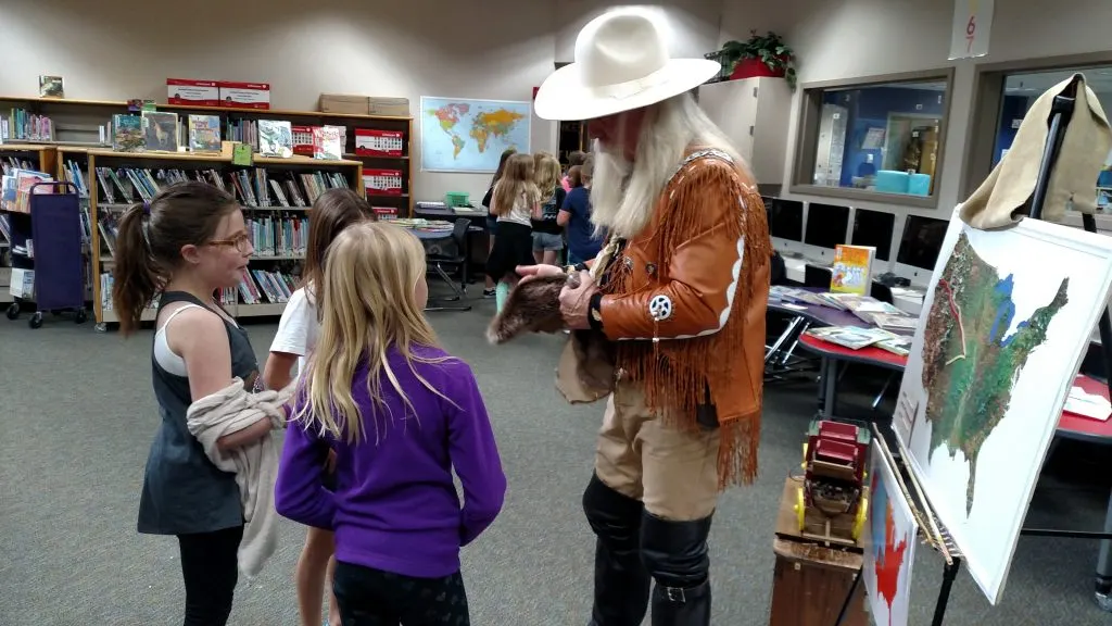 These young ladies stayed after the show to talk with "Buffalo Bill" about how beaver pelts were made into hats!